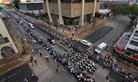 The procession for former South African president Nelson Mandela makes its way through the streets of Pretoria, South Africa, Wednesday, Dec. 11, 2013. 