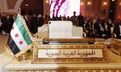 The Syrian opposition flag is seen in front of the seat of the Syrian delegation at the opening the Arab League summit in Doha March 26, 2013. 