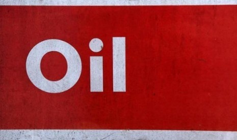 The word oil is pictured on an oil bank at a recycling yard in London March 2, 2011.