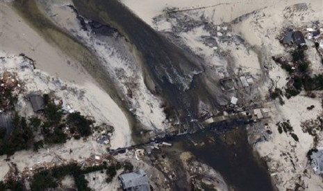 This aerial photo shows a new break in the island across Route 35 at the Herbert Street bridge in Mantoloking, N.J. in the aftermath of Superstorm Sandy Thursday, Nov. 1, 2012. The photo was taken during a National Oceanic and Atmospheric Administration fl