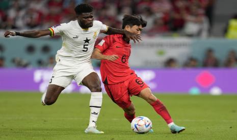 Thomas Partey dari Ghana, pergi, berduel memperebutkan bola dengan Hwang In-beom dari Korea Selatan selama pertandingan sepak bola grup H Piala Dunia antara Korea Selatan dan Ghana, di Stadion Education City di Al Rayyan, Qatar, Senin, 28 November 2022. 