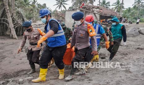 Tim penyelamat membawa jenazah korban di kawasan yang terkena dampak erupsi Gunung Semeru di Lumajang, Jawa Timur, Senin (6/12.). Gunung meletus pada 04 Desember, menewaskan sedikitnya 14 orang dan menyebabkan puluhan lainnya luka-luka. 