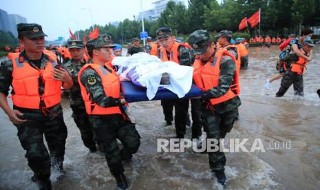 Tim penyelamat mengevakuasi orang dari sebuah rumah sakit tempat sekitar 3.000 orang terjebak banjir di Zhengzhou, provinsi Henan, China tengah, 22 Juli 2021. Tiga puluh tiga orang ditemukan tewas dalam banjir tersebut, dan delapan lainnya hilang. 