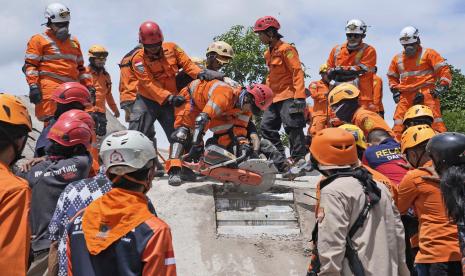  Tim penyelamat menggunakan gergaji saat mereka mencoba mengevakuasi jenazah korban gempa bumi dari bawah reruntuhan bangunan yang runtuh di Cianjur, Jawa Barat, Indonesia, Selasa, 22 November 2022. Tim penyelamat pada Selasa berjuang untuk menemukan lebih banyak jenazah dari puing-puing rumah dan bangunan yang roboh akibat gempa bumi yang menewaskan sejumlah orang dan melukai ratusan orang di pulau Jawa utama Indonesia.