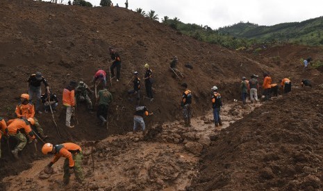  Tim SAR gabungan melakukan pencarian korban yang tertimbun longsor di Desa Banaran, Kecamatan Pulung, Ponorogo, Jawa Timur, Ahad (2/4). 