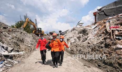 Tim SAR mengevakuasi seorang korban gempa yang tercebur lumpur di Kompleks Perumahan Kelurahan Petobo Palu, Sulawesi Tengah (2/10).