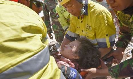 Tim siaga bencana AMNT bersama anggota TNI berusaha mengeluarkan korban selamat dari runtuhan akibat gempa di Desa Pemenang Timur, Kecamatan Pemenang, Tanjung, Lombok Utara, NTB, Selasa (7/8).