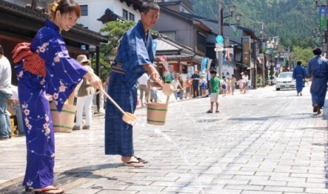 Musim panas di Jepang, masyarakat setempat harus menyiram jalan dengan air untuk menghindari radiasi debu.