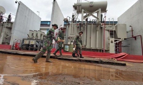 TNI dan Polri membantu membersihkan gardu listrik PLN, pascabanjir.