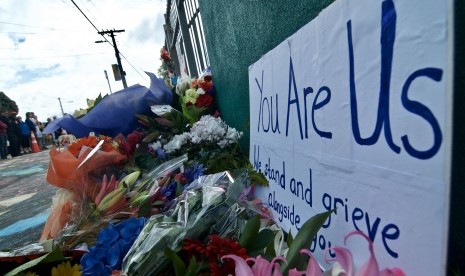 Tulisan pesan perdamaian dan bunga diletakkan warga di depan Masjid Wellington, Kilbirnie, Wellington, Selandia Baru, Sabtu (16/3/2019). 