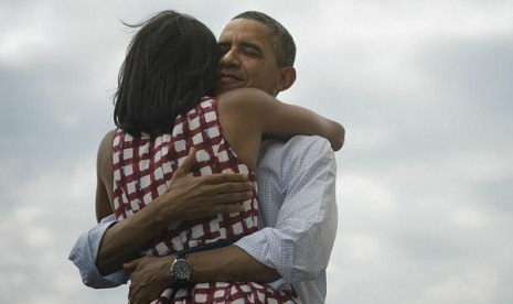 Tweet Obama yang bertuliskan 'Four more years' dan tampak memeluk mesra sang istri Michelle membuat kehebohan besar di jagad Twitter.