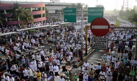  Umat Muslim tengah mengikuti Shalat Idul Fitri di pelataran jalan Pasar Senen, Jakarta Pusat, Kamis (8/8).  (Republika/ Yasin Habibi)