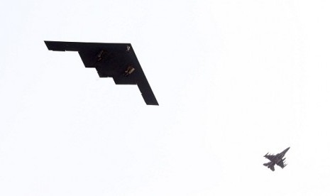 US Air Force B-2 stealth bomber, left, flies over near Osan US Air Base in Pyeongtaek, south of Seoul, South Korea, Thursday, March 28, 2013. 