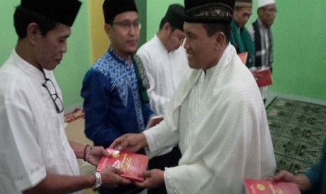 Ustadz Hasan Basri Tanjung menyerahkan hadiah buku 