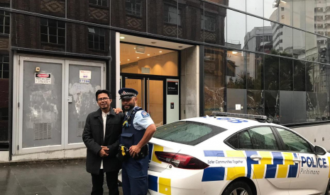 Ustaz Kopri Nurzen saat berpose dengan seorang petugas kepolisian di Auckland, Selandia Baru, Senin (13/5)