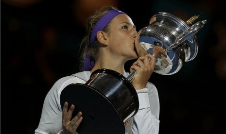 Victoria Azarenka, petenis asal Belarusia, berpose bersama trofi The Daphne Akhurst Memorial usai menaklukan petenis Cina, Li Na, di final Australia Terbuka di Melbourne pada 26 Januari. 