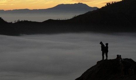 Villagers stand on a crater of Mount Bromo as they wait for sunrise. Bromo crater is among 16 new tourist destiations as part of ecological tourism to attract more foreign tourists to Indonesia. 