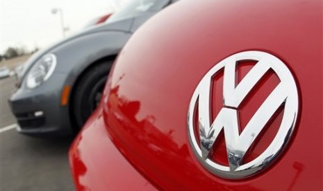 Volkswagen logo shows on the hood of a 2012 Beetle at a Volkswagen dealership in the south Denver suburb of Littleton, Colo. 