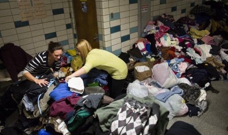 Volunteers at Hoboken High School sort through clothing donations intended for distribution to the public, in Hoboken, N.J. Donations are rolling into New York and New Jersey after Superstorm Sandy, but some relief experts say the things being given are no