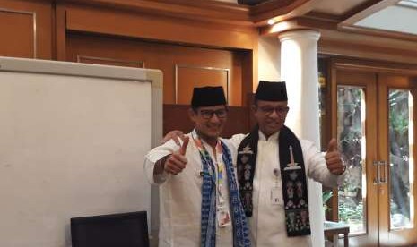 Wakil Gubernur DKI Jakarta Sandiaga Salahuddin Uno dan Gubernur DKI Jakarta Anies Rasyid Baswedan berpelukan dan bertukar syal dalam momen perpisahan di Ruang Gubernur, Balai Kota, Jalan Medan Merdeka Selatan, Jakarta Pusat, Jumat (10/8).