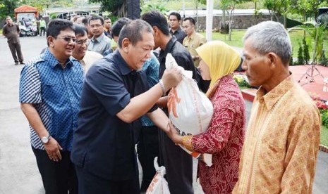 Wakil Gubernur Jabar, Deddy Mizwar secara simbolis memberikan beras raskin pada acara pelepasan truk Pendistribusian Beras Rakin 2014 di halaman belakang Gedung Sate, Kota Bandung, Rabu (22/1).