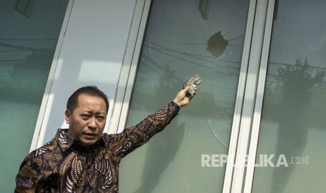 Wakil Ketua DPP PPP Humphrey Djemat menunjukkan barang bukti batu dan kaca yang rusak akibat penyerangan oleh orang tak dikenal di Kantor DPP PPP kubu Djan Faridz, jalan Diponegoro, Jakarta, Minggu (16/7).