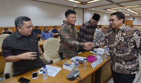 Wakil Ketua DPR Fadli Zon (kanan) berjabat tangan dengan sejumlah anggota Panitia Khusus (Pansus) RUU Penyelenggaran Pemilihan Umum (Pemilu) sebelum berlangsungnya rapat di Kompleks Parlemen, Senayan, Jakarta, Senin (21/11). 