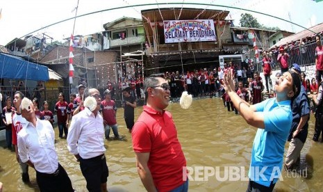 Wali Kota Bandung Ridwan Kamil (berkacamata) dan wakilnya Oded M Danial (kanan) beserta jajaran SKPD mengikuti lomba makan kerupuk, di Kelurahan Lebak Siliwangi, Kecamatan Coblong, Rabu (17/8). (Republika/Zuli Istiqomah)