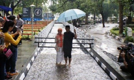 Wali Kota Bandung Ridwan Kamil bersama istri Atalya Kamil mencoba aliran air sungai Cikapayang yang bisa digunakan untuk therapi, Bandung, Jawa Barat, Kamis (31/12).