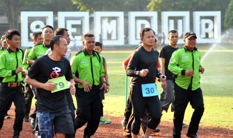 Walikota Bogor Bima Arya (kedua kanan) berlari bersama petugas penjaga taman saat Tes Kebugaran Fisik PNS Bogor di Taman Sempur, Bogor, Jawa Barat, Jumat (26/5).