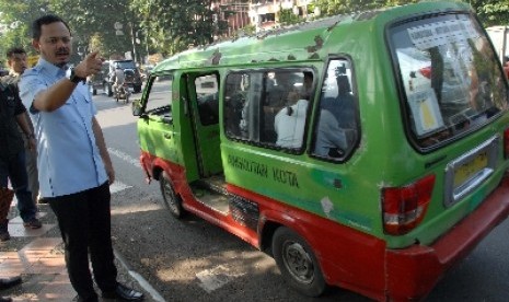 Walikota Bogor, Bima Arya Sugiarto menunggu kedatangan angkutan kota rute Bubulak-Sukasari untuk menumpang menuju agenda kerja di Jalan Djuanda, Kota Bogor, Jabar, Senin (24/11). 