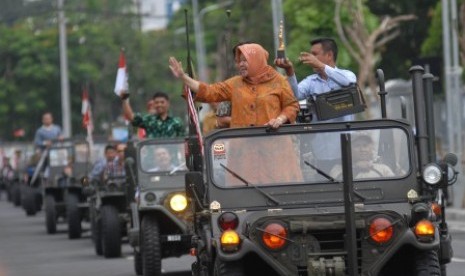 Walikota Surabaya Tri Rismaharini (kedua kanan) mengarak tropi penghargaan Socrates ketika tiba di Balai Kota Surabaya, Jawa Timur, Ahad (20/4).