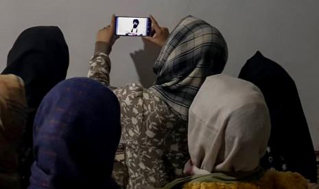  Wanita Afghanistan menonton pidato menteri pendidikan tinggi Taliban, Nida Muhammad Nadeem, melalui ponsel di Kabul, Afghanistan, 22 Desember 2022. Nida Muhammad mengatakan dalam sebuah wawancara televisi bahwa pelarangan perempuan dari universitas dilakukan karena beberapa isu yang bertentangan hukum Syariah seperti tidak mengikuti pemisahan gender, di beberapa universitas jilbab yang tepat tidak diikuti dan perubahan kurikulum harus dilakukan untuk mengecualikan mata pelajaran yang tidak bermanfaat bagi perempuan untuk dipelajari. Taliban yang berkuasa telah melarang perempuan untuk kuliah di universitas di Afghanistan , menurut perintah yang dikeluarkan pada 20 Desember 2022. Setelah mendapatkan kembali kekuasaan, Taliban awalnya bersikeras bahwa hak-hak perempuan tidak akan dihalangi, sebelum melarang anak perempuan berusia di atas 12 tahun untuk bersekolah awal tahun ini. Taliban Larang Perempuan Bekerja di LSM Nasional dan Internasional