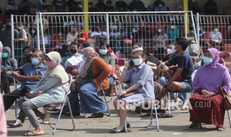 Warga antre mendapatkan suntikan vaksin COVID-19 di Stadion Canda Bhirawa, Kediri, Jawa Timur, Sabtu (26/6/2021). Pemberian vaksin massal untuk masyarakat berusia di atas 18 tahun tersebut guna mendukung vaksinasi nasional satu juta orang per hari. 