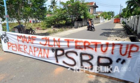 Warga berbalik arah karena penutupan jalan di kawasan Jati, Padang, Sumatera Barat, Rabu (22/4/2020). PSBB diterapkan di Padang dan kabupaten/ kota lain di provinsi itu mulai Rabu (22/4/2020) hingga 5 Mei 2020 untuk menghentikan penyebaran COVID-19, diantaranya dengan membatasi aktivitas di luar rumah, wajib menggunakan masker serta pembatasan jumlah penumpang kendaraan roda empat dan roda dua. 