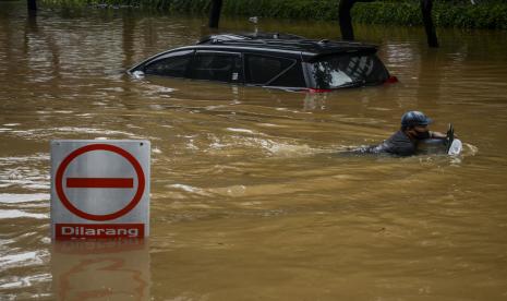 Warga berenang melewati banjir di kawasan Kemang, Jakarta, Sabtu (20/2).