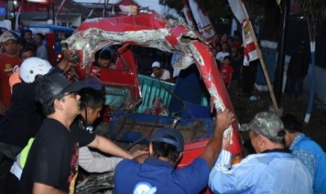 Warga bergotong-royong melakukan evakuasi bangkai mobil mikrolet bernopol N 1801 UG yang ringsek usai terlibat kecelakaan beruntun di Karangploso, Malang, Jawa Timur, Jumat (25/8). Kecelakaan beruntun yang melibatkan satu truk tronton, dua mobil dan tiga sepeda motor tersebut mengakibatkan empat korban tewas dan belasan lainnya luka-luka. 