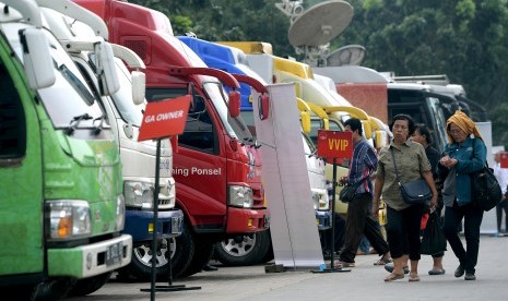 Warga berjalan menuju mobil kas keliling penukaran uang pecahan di Lapangan IRTI, Monas, Jakarta, Senin (5/6).