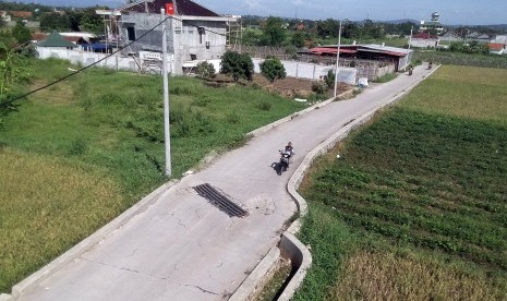 Warga berkendara di jalan yang dibangun mengunakan dana desa 2018, di Desa Laladon, Bogor, Jawa Barat, Jumat (28/12/2018). 