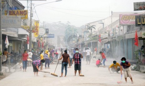  Warga bersama petugas TNI dan Kepolisian membersihkan abu vulkanik yang menyelimuti Jalan MT Haryono, Kutoarjo, Purworejo, Jawa Tengah, Sabtu (15/2). (Republika/Adhi Wicaksono)