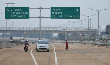 Warga dengan menaiki sepeda motor melintasi ruas Tol Jakarta Outer Ring Road West 2 (JORR W2) seksi Ciledug - Ulujami, Jakarta Selatan, Kamis (26/6). PT Jasa Marga Tbk memastikan ruas Tol Jakrta Outer Ring Road West 2 (JORR W2) seksi Ciledug - Ulujami yang