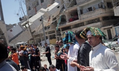 Warga Jalur Gaza berdoa setelah masjid di sana hancur akibat serangan roket militer Israel.