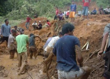 Warga Kampung Sawah Peuteuy, Garut, bergotong royong membersihkan tumpukan tanah akibat bencana longsor pada Ahad (8/5).