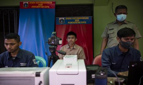 Warga melakukan foto untuk perekaman KTP Elektronik saat berlangsung layanan jemput bola penyesuaian dokumen kependudukan terdampak perubahan nama jalan di halaman Masjid Guru Amin, SMK Karya Teladan, Jakarta Selatan, Senin (4/7/2022). Dinas Kependudukan dan Pencatatan Sipil Provinsi DKI Jakarta secara proaktif melakukan layanan jemput bola penyesuaian dokumen kependudukan bagi warga yang mengalami penggantian nama jalan. 