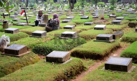  Warga memanjatkan doa ketika berziarah ke makam salah satu keluarganya di TPU Karet, Jakarta,Selasa (2/7).  (Republika/Agung Supriyanto)