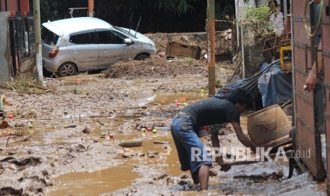 Warga membersihkan lumpur sisa banjir bandang di kawasan perumahan daerah Jatihandap, Kota Bandung, Rabu (21/3).