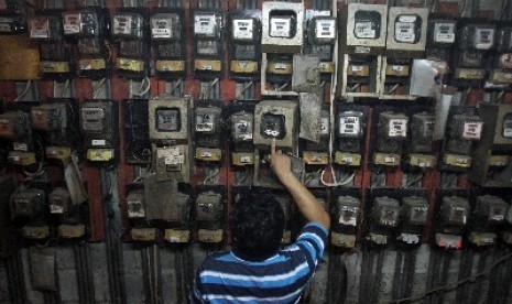 Warga memeriksa meteran listrik, di Rumah Susun Tanah Tinggi, Jakarta, Senin (30/6).