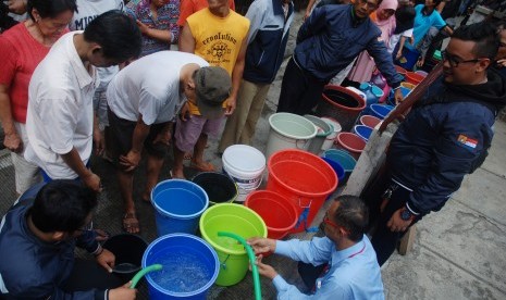 Warga mengantre saat pemberian bantuan air bersih oleh PDAM Tirtawening Kota Bandung di kawasan Muararajeun Kaler, di Bandung, Jawa Barat, Senin (4/9). 