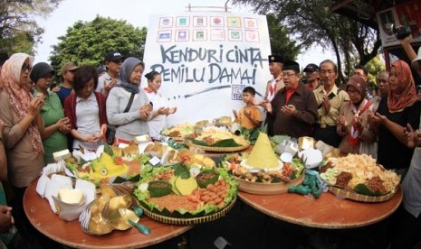 Warga menggelar tumpengan bersama guna menyambut datangnya Pemilu 2014 di Solo, Jateng, Minggu (6/4). Dalam kegiatan tersebut mereka juga melakukan doa bersama agar Pesta demokrasi mendatang berjalan dengan lancar dan aman.