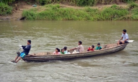 Warga menggunakan perahu pengangkut pasir, untuk menyeberangi Sungai Batang Anai, di Nagari Sikabu, Lubuk Alung, Padangpariaman, Sumatra Barat.